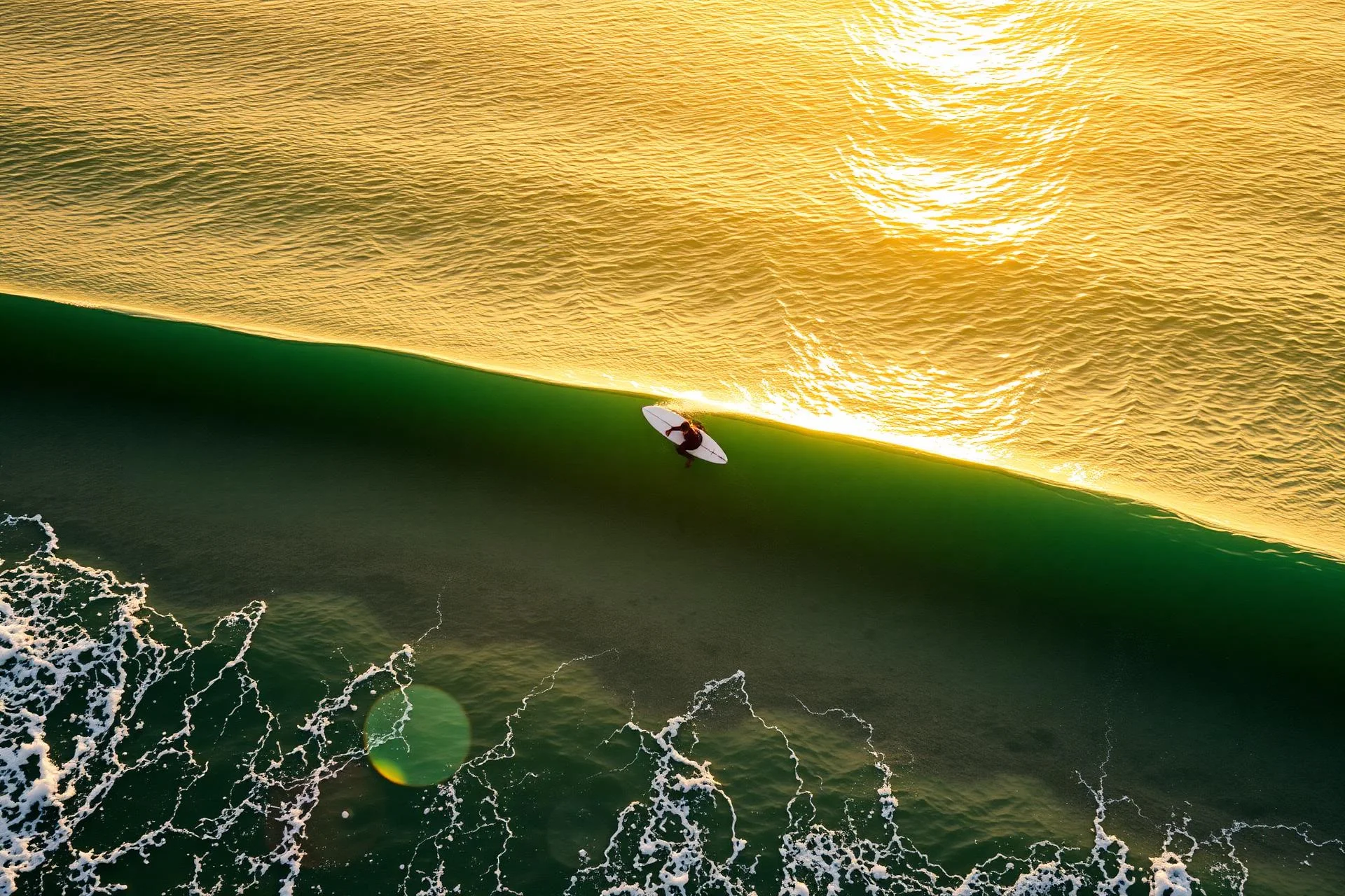 A surfer riding a clean green wave at sunset on Morocco's Atlantic coast