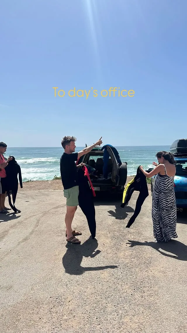 Jamal and surf-lesson guests arriving at a Taghazout Bay break with boards under arm