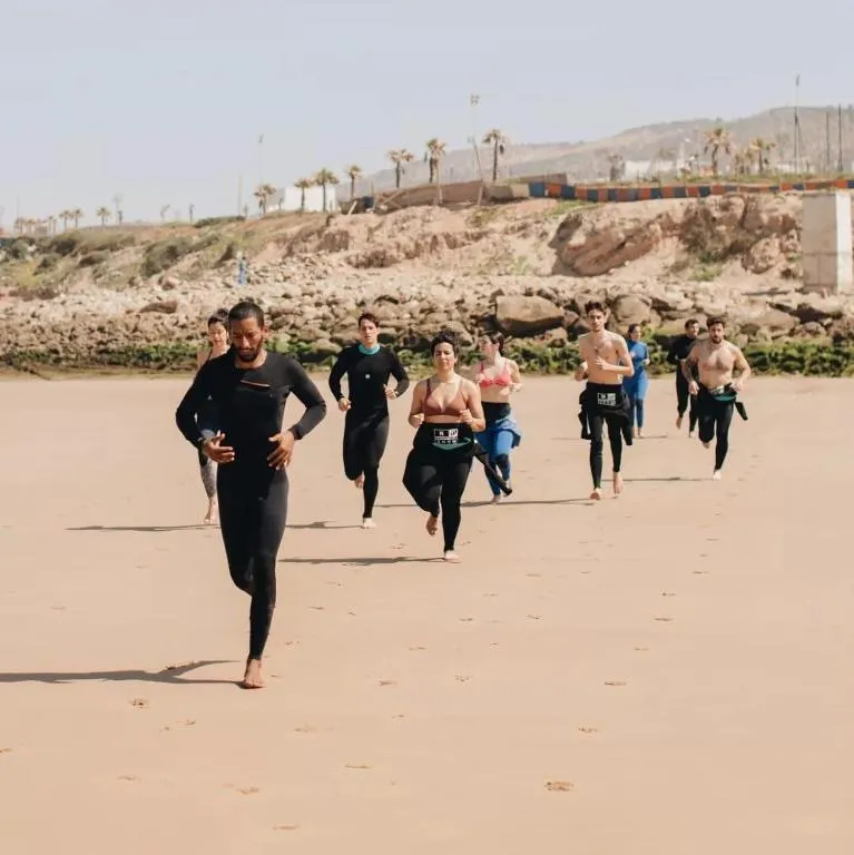 Jamal leading a warm-up routine before a coached surf session